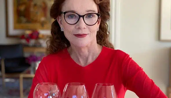 karen in front of three wine glasses